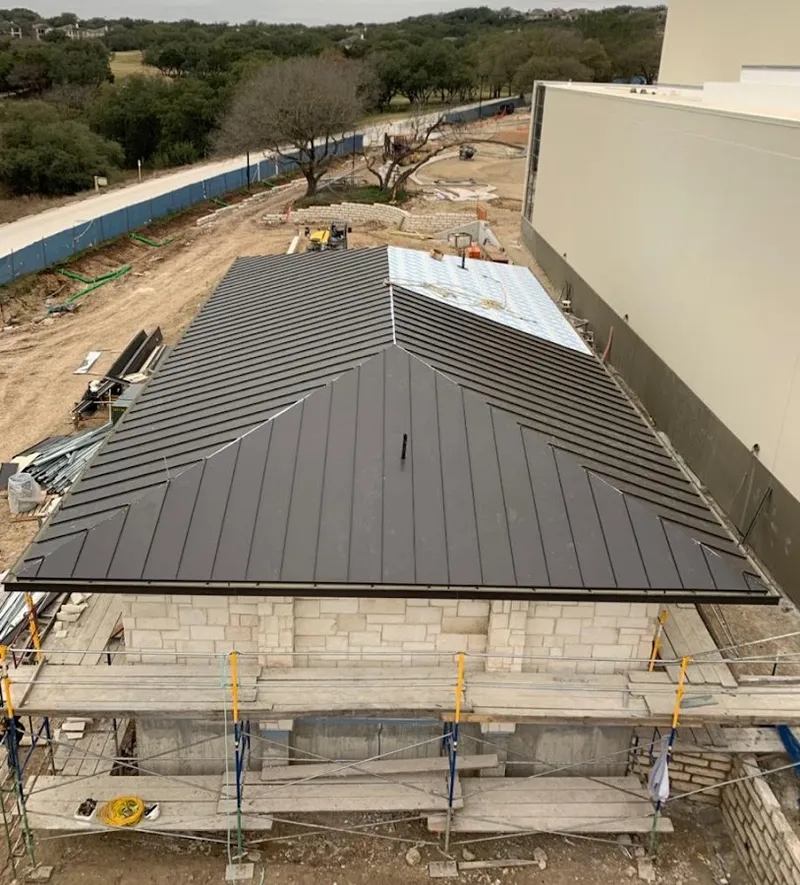 Metal roof new construction with scaffolding in Albion
